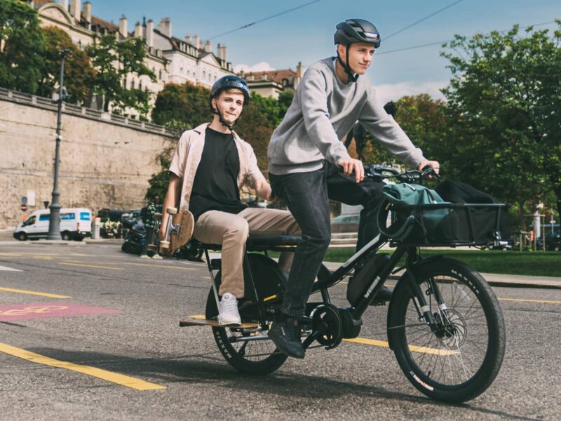 2 teenagers in cycle lane on Yuba compact electric cargo bike Kombi E6